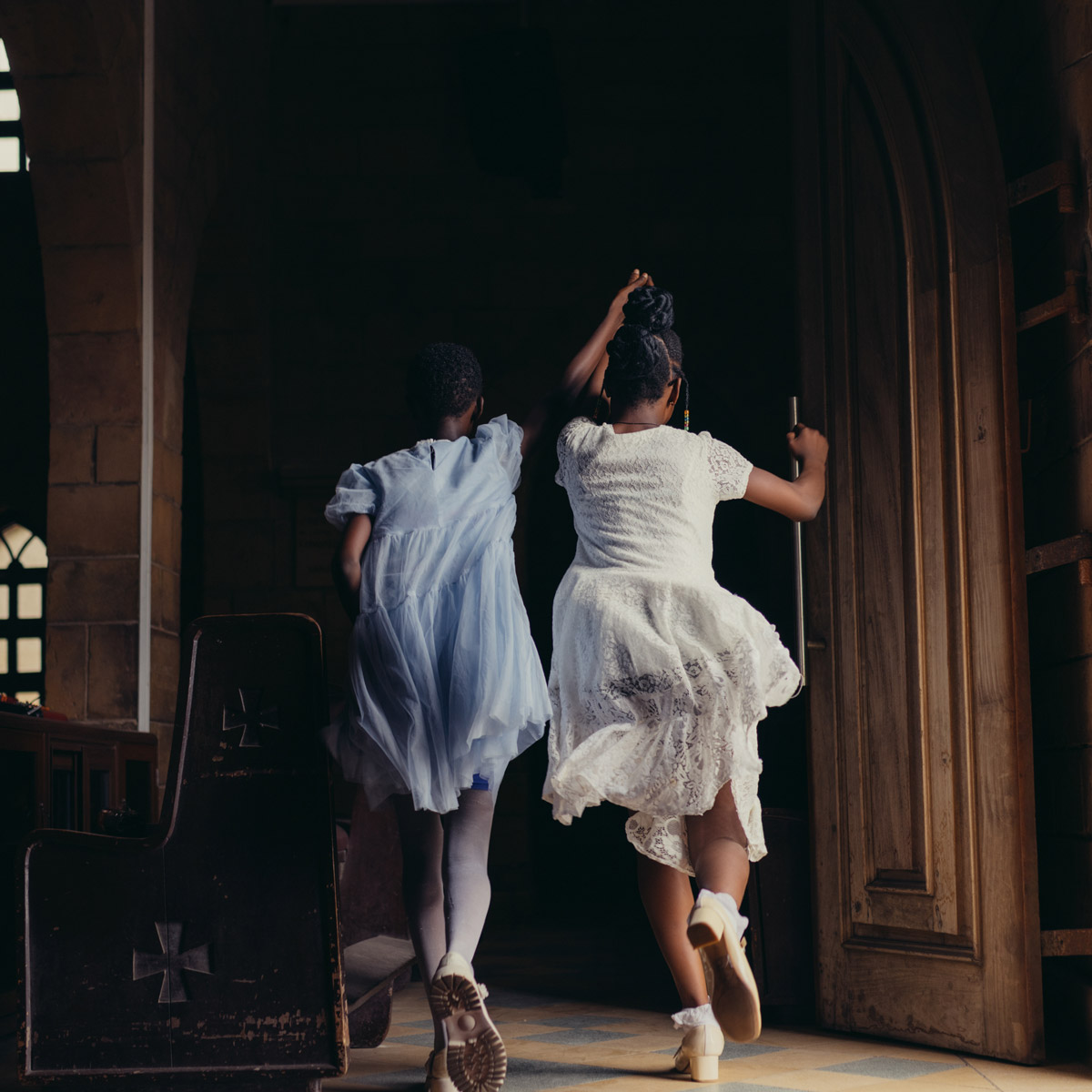 Photo of two children playing in church